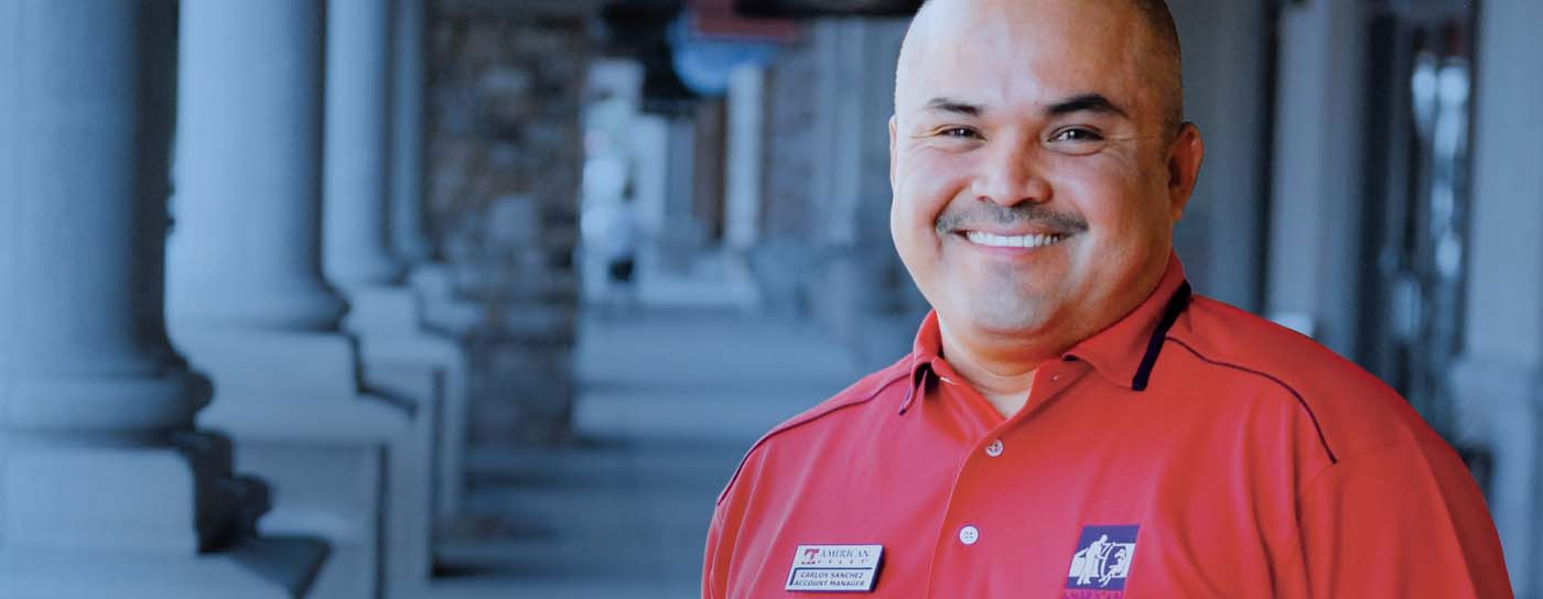 A valet parking professional smiling and wearing a uniform